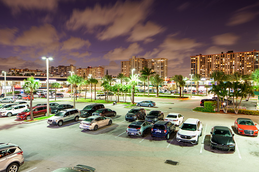 Sunny Isles Beach, FL, USA - August 1, 2022: Low aerial photo RK Shopping Plaza Sunny Isles Beach at night