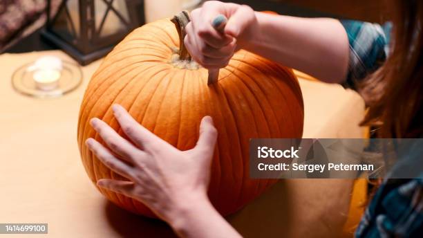 Woman Carving Jack O Lantern Pumpkin For Halloween Stock Photo - Download Image Now - 30-34 Years, Adult, Adults Only