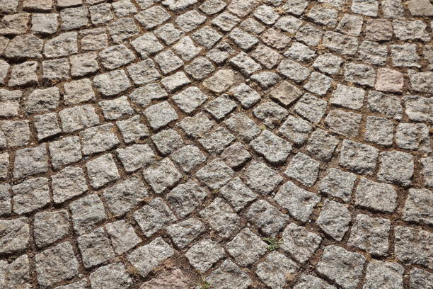 istock Pattern bricks pavement closeup old european road of stones and bricks 1414699952