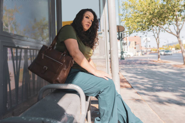 istock Woman at bus station 1414702780