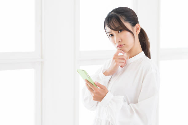 istock attractive Asian woman using a smart phone,think, 1414708811