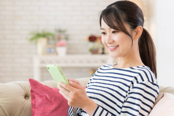 istock attractive Asian woman using a smart phone 1414708828