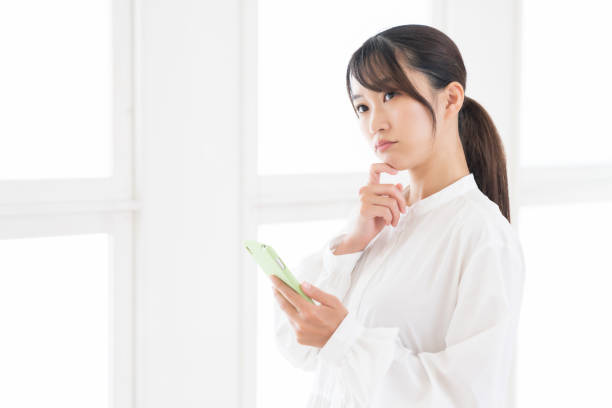 istock attractive Asian woman using a smart phone,think, 1414708857
