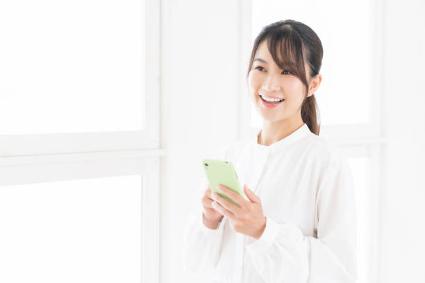 istock attractive Asian woman using a smart phone 1414708881
