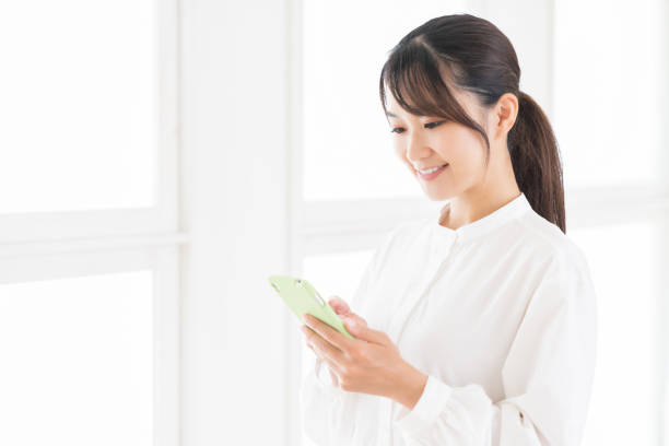 istock attractive Asian woman using a smart phone 1414708903
