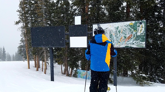 Colorado Rockies Scenery, skier looking at a trailmap in Copper Mountain, Colorado