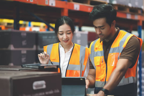istock Warehouse worker and manager checks stock and inventory with digital tablet computer in the retail warehouse full of shelves with goods. Working in logistics, Distribution center. 1414722084