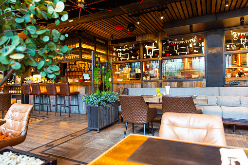 Interior of modern loft style restaurant with live plants