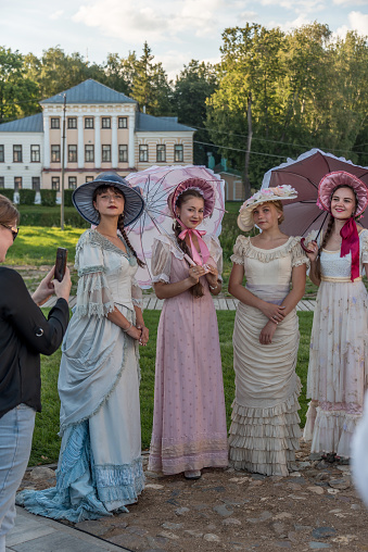 Girls in old-fashioned dresses of the last century at a city festival. Uglich, Russia - August 13, 2022.