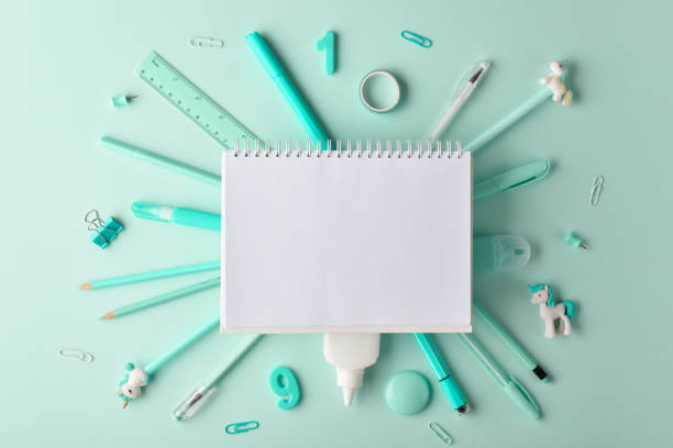 The layout of a white notebook on a stationery background on a light turquoise background. Back to schoo The layout of a white notebook on a stationery background on a light turquoise background. Back to school back to schoo stock pictures, royalty-free photos & images