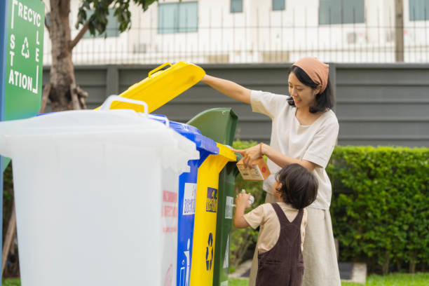 istock Asian Mother and son put garbage in the bin. 1414734864