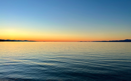 Scenic view of the bright colourful twilight overlooking the Mediterranean sea with the hills and the islands in Mugla province, Turkey