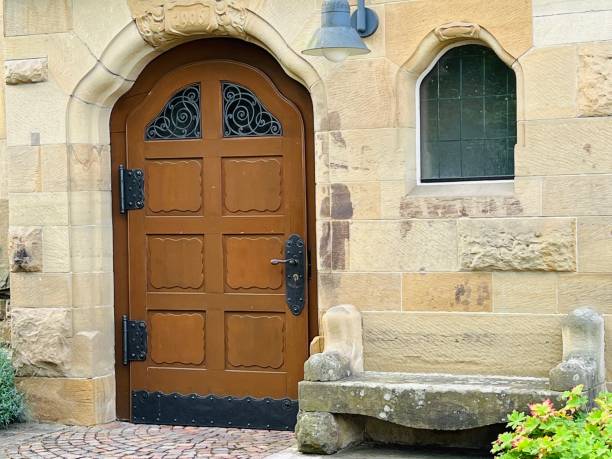 istock Church entrance with a stone bench 1414738131