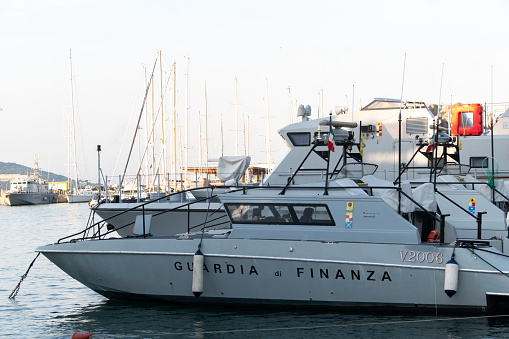 Nautical vessels at the Formia harbour, Italy. The Guardia di Finanza is an Italian law enforcement agency under the authority of the Minister of Economy and Finance. No people. Daylight.