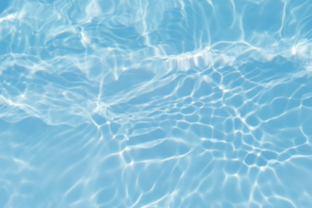 istock Defocus blurred transparent blue colored clear calm water surface texture with splashes and bubble. Trendy abstract nature background. Water wave in sunlight with copy space. Blue watercolor texture 1414740219