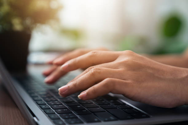 istock Woman using laptop and hand typing on the computer keyboard in the office. 1414744611