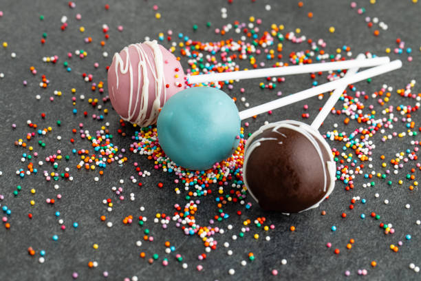 various homemade cake pops on dark stone