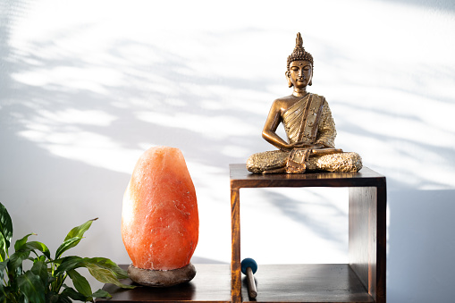 Golden Buddha and Himalayan salt lamp