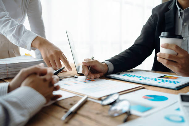 istock Professional management business team brainstorm meetings to plan investment projects, work together and analyze market data graphs. 1414756366