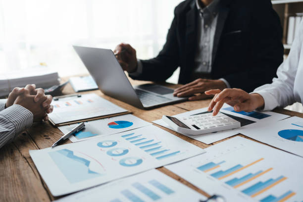 istock Professional management business team brainstorm meetings to plan investment projects, work together and analyze market data graphs. 1414756371