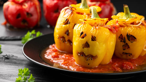 Jack o lanterns stuffed yellow pepper for Halloween.