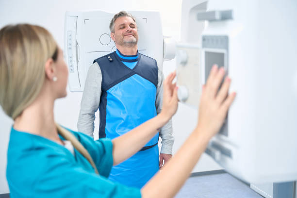istock Doctor adjusts the head x-ray machine in clinic 1414762378