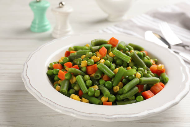 istock Mix of fresh vegetables served on white wooden table 1414762554