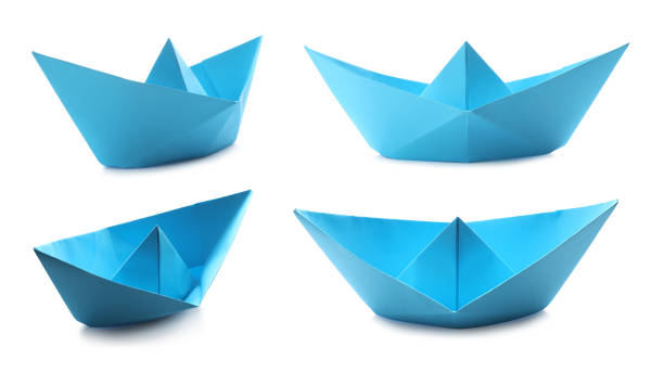 istock Set with light  blue paper boats on white background 1414764276