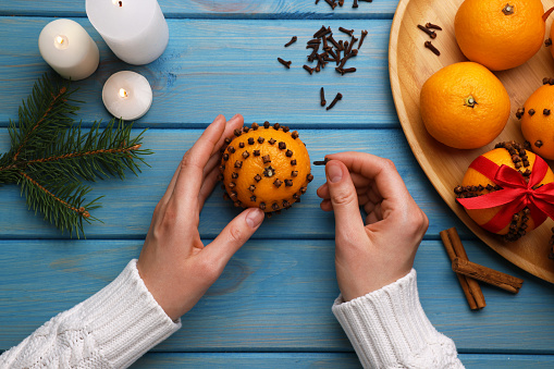 Christmas background with winter traditional spices to improve immunity during the cold period. Star anise, cinnamon and dried oranges and tangerines on a dark background with fir branches. New Year's Eve and Christmas concept, selective focus