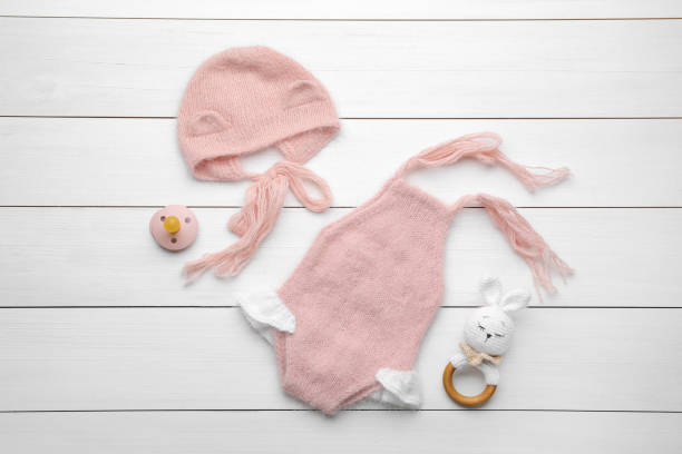 istock Flat lay composition with child's clothes and accessories on white wooden table 1414765161