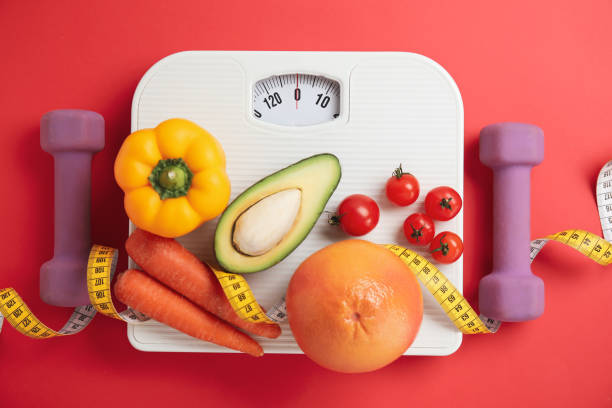 flat lay composition with scales and healthy food on red background - weight scale dieting weight loss imagens e fotografias de stock