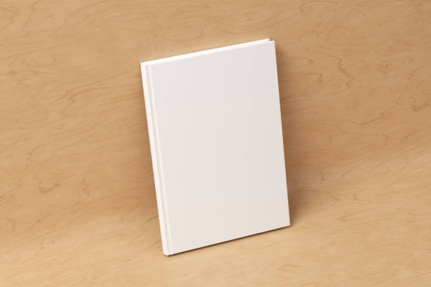 istock Blank vertical hardcover book cover mockup standing on wooden background 1414767561