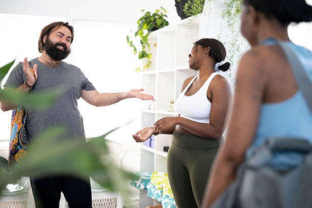 istock Young gay man thanking yoga instructor for class 1414767917