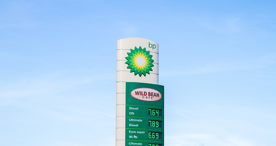 Skawina, Poland - March 27, 2022: BP and Wild Bean Cafe sign outside a petrol station. British Petroleum logo at filling gas station forecourt with prices displayed on a pylon.