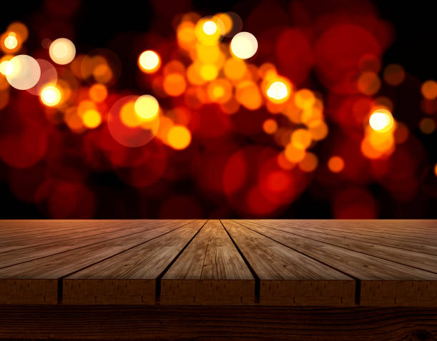 istock Wooden table top on shining bokeh background. concept for chossing best design 1414769850
