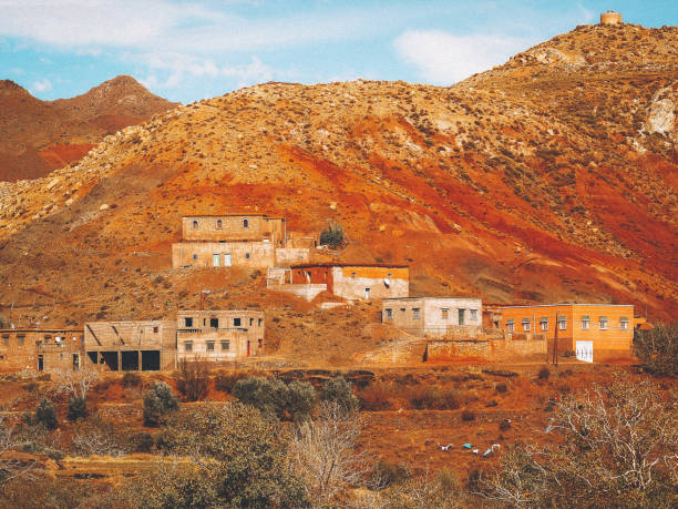 Typical Moroccan buildings made of clay surrounded by  brown hills