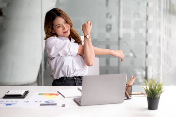 istock Woman Working  On Computer In Home Office and Stretching At Desk. 1414770842