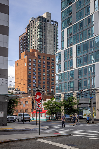 Long Island City, Queens, New York, NY, USA - July 6th 2022: Street corner with view to a outdoor restaurant and old and new architecture