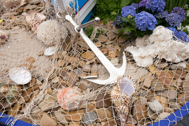 istock Anchor, fishing net, sea pebbles and shells close-up. 1414772064