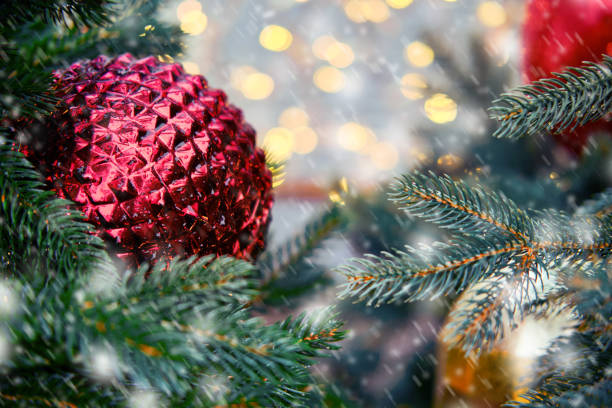 istock Big red balls on a snow branch christmas tree, copy space 1414774255