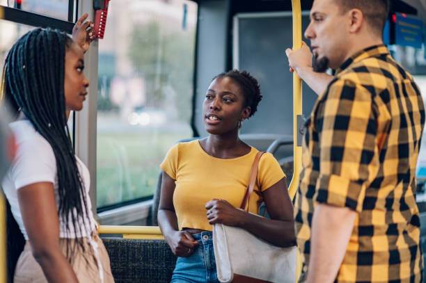 istock Multiracial group of friends talking while riding in a bus 1414774308