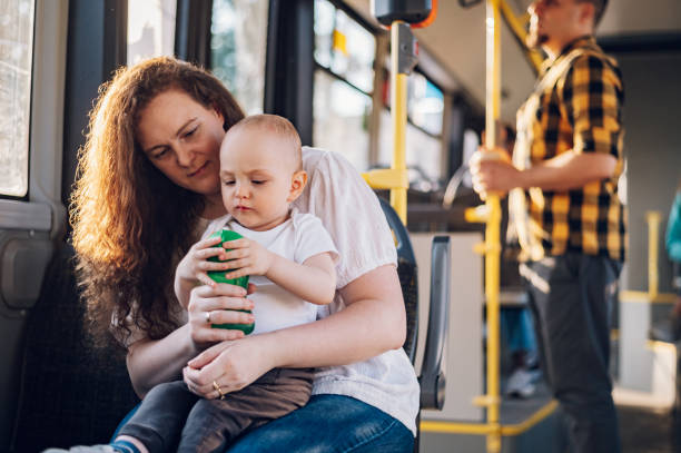 istock Mother and her child riding in a bus during a day. 1414774311