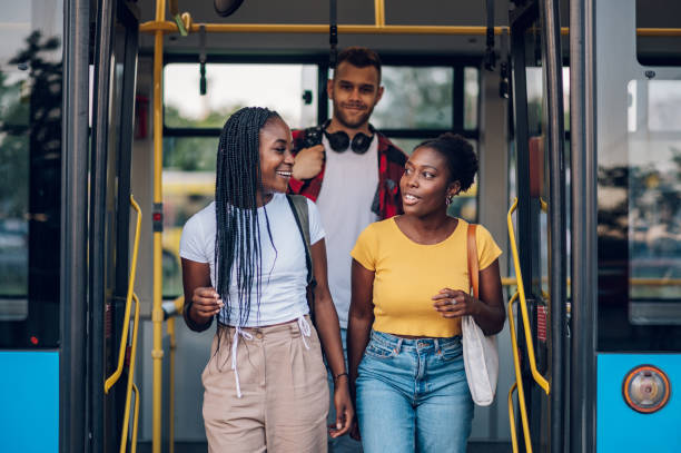 istock Multiracial friends getting of the bus 1414774312