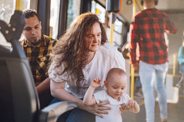 istock Parents riding a bus with their child during a day. 1414774317