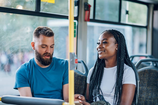 istock Multiracial friends talking while riding a bus in the city 1414774328