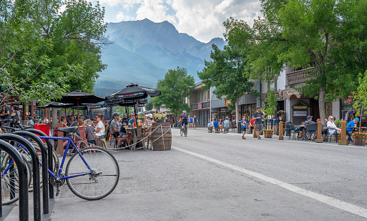 Canmore, Alberta, Canada – August 13, 2022:  People dine on outdoor patios on the closed main street