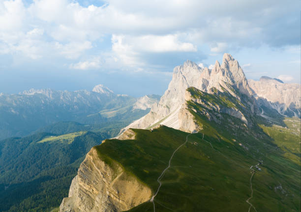 View from above, stunning aerial view of the mountain range of Seceda during a beautiful sunny day. The Seceda with its 2.500 meters is the highest vantage point in Val Gardena, Dolomites, Italy stock photo