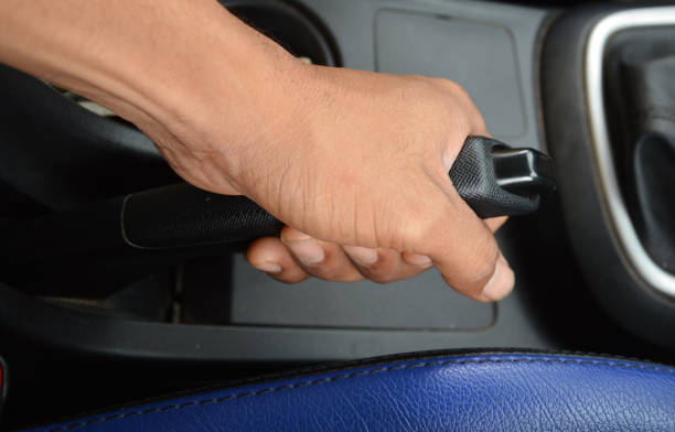 istock Black handbrake lever puller. Concept of parking properly and safely. 1414775799