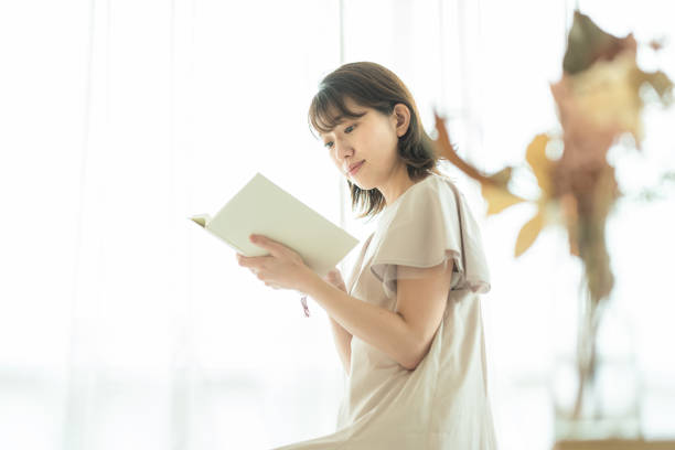 istock Japanese woman reading a book 1414776907