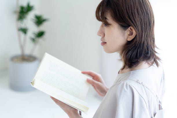istock Japanese woman reading a book 1414777078